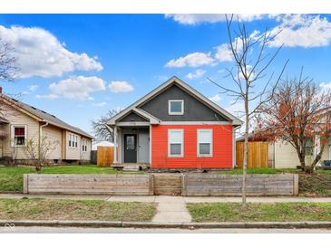 Charming home featuring a well-kept front yard and a colorful two-tone exterior at 1715 E Kelly St, Indianapolis, IN 46203