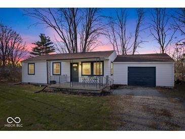 Charming home featuring a manicured lawn, covered porch, and an attached garage, great for outdoor entertaining at 300 Indiana Ave, Pendleton, IN 46064