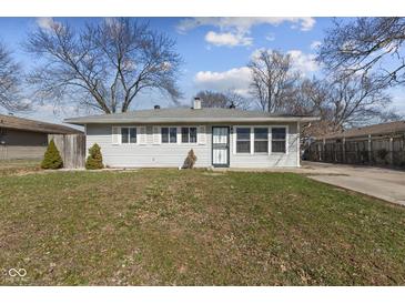 Charming single-story home featuring gray siding, white trim, and a well-maintained lawn on a sunny day at 3109 Welch Dr, Indianapolis, IN 46224