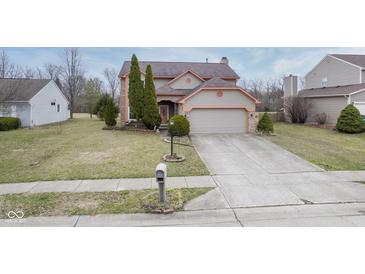 Charming two-story home with attached two-car garage and well-manicured landscaping at 7531 Bancaster Dr, Indianapolis, IN 46268