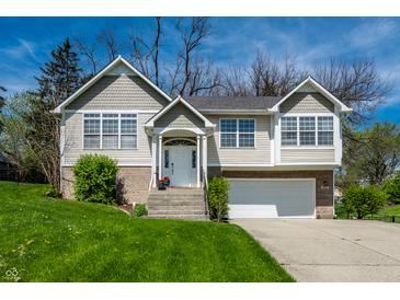 Charming home with two-car garage, white trim, front lawn, and well-maintained landscaping at 5836 Andover Rd, Indianapolis, IN 46220