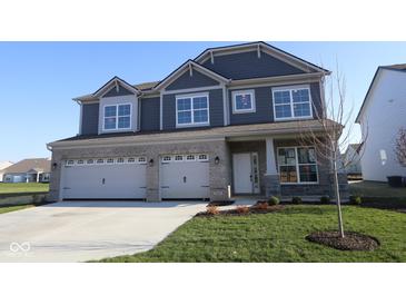 Charming two-story home with a three-car garage and a well-manicured lawn, perfect for curb appeal at 10609 Banyan Wood Ct, Indianapolis, IN 46239