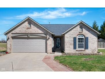 Charming brick home with a two-car garage, well-maintained lawn, and inviting front entrance at 1494 Mimosa Ct, Greenfield, IN 46140