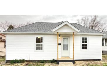 Charming single-story home with a fresh white exterior and inviting front porch at 1640 W 7Th St, Anderson, IN 46016