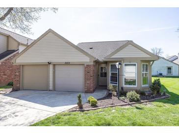 Charming home with a two-car garage, tidy landscaping, and great curb appeal at 3013 Crimson W Ct # 42, Carmel, IN 46033