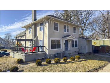 Charming two-story home featuring a cozy front porch, a well-maintained yard, and neutral-colored siding at 952 E 34Th St, Indianapolis, IN 46205
