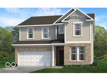 Charming two-story home featuring a brick and siding exterior with an attached two-car garage and neatly landscaped yard at 13752 N George Ct, Camby, IN 46113