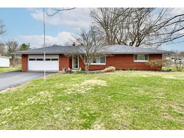 Charming single-story brick home with attached garage and well-maintained front yard at 2315 Cardinal Dr, Indianapolis, IN 46227