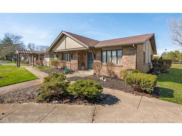 Charming brick home featuring manicured landscaping and inviting curb appeal at 3875 Offshore Dr, Columbus, IN 47203
