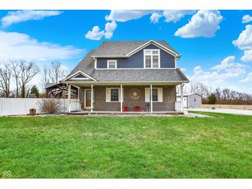 Charming two-story home featuring a covered porch and a well-maintained lawn at 5371 Lue Ann Ln, Mooresville, IN 46158