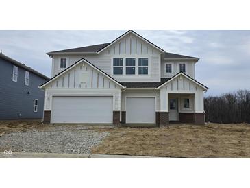 Charming two-story home with a two-car garage, white siding, and beautiful architectural details at 5803 Sunstone Rd, Indianapolis, IN 46239