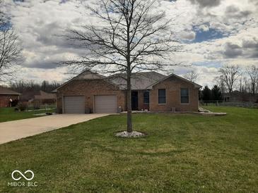 Charming single-story brick home with an attached two-car garage and a well-manicured front lawn at 791 W 500 S, Greenfield, IN 46140