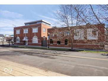 Brick building featuring an inviting front entrance with arched windows, plus professionally landscaped grounds at 1529 N Alabama N St # B, Indianapolis, IN 46202