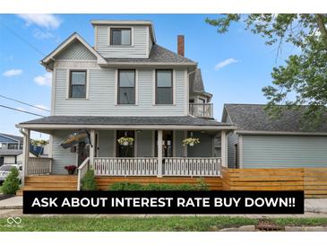 Charming two-story home with a welcoming front porch, beautiful landscaping, and attractive curb appeal at 1665 N College Ave, Indianapolis, IN 46202