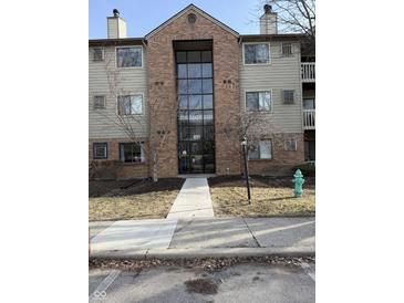 Apartment building with brick facade and a walkway leading to the entrance at 4291 Village Parkway W Cir # 8, Indianapolis, IN 46254
