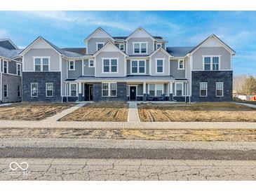 Attractive townhome with gray siding, black brick accents, and inviting front porches at 5777 Cr W 750 N, McCordsville, IN 46055