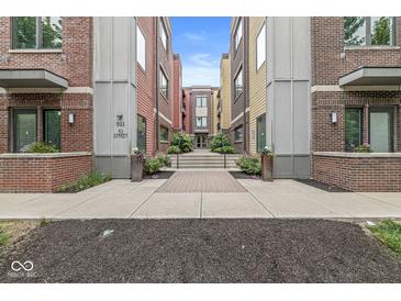 Colorful condo building featuring a well-maintained walkway and manicured landscaping, creating an inviting entrance at 622 E 10Th St # 206, Indianapolis, IN 46202