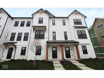 Charming two-story townhome featuring a white exterior, black-trimmed windows, and a covered entryway at 7081 Pate Hollow Dr, Brownsburg, IN 46112