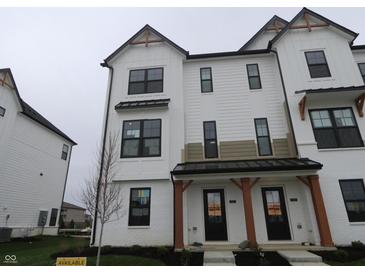 Modern townhome showcases a white facade with black accents and covered entrance at 7093 Pate Hollow Dr, Brownsburg, IN 46112