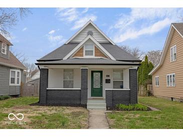 Charming home with a well-manicured lawn, appealing front door, and attractive architectural details at 843 N Oxford St, Indianapolis, IN 46201
