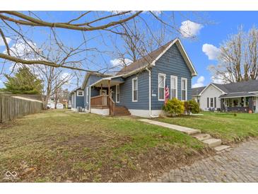 Lovely blue house with a covered porch, green lawn and beautiful curb appeal at 1240 Wayne St, Noblesville, IN 46060