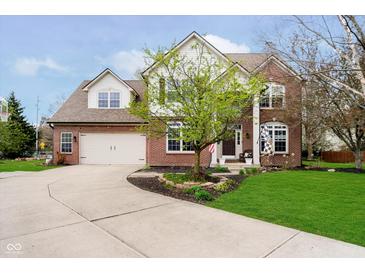Charming two-story brick home with well-manicured lawn and attached two car garage at 15638 River Birch Rd, Westfield, IN 46074