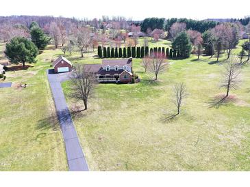 Expansive property with a charming brick home, detached garage, and a long driveway at 195 Hess Rd, Martinsville, IN 46151