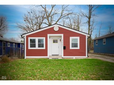 Charming home featuring red siding, a white door, and well-maintained landscaping at 3045 N Lasalle St, Indianapolis, IN 46218