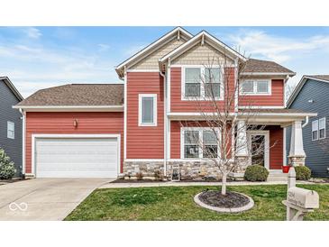 Charming two-story home with a red exterior, stone accents, and a well-maintained lawn at 7254 Cambridge Pl, Avon, IN 46123