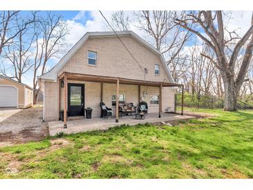 View of backyard with covered patio and furniture at 7845 Bluff Rd, Indianapolis, IN 46217