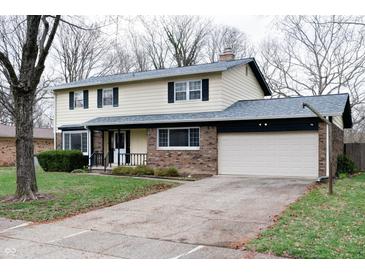 Charming two-story home with a brick and siding exterior, attached two car garage, and a well-manicured front yard at 8151 Taunton Rd, Indianapolis, IN 46260