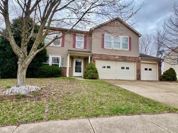 Charming two-story home with a well-maintained lawn and a two-car garage at 1426 Ripplewood Dr, Danville, IN 46122