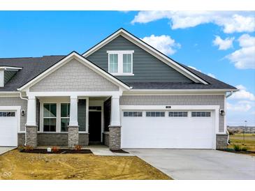 Charming two-story home featuring a two-car garage and covered porch with stone accents and stylish gray siding at 268 Onset Way, Westfield, IN 46074