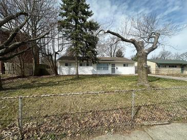 Charming single-story home featuring a well-maintained lawn and mature trees in a suburban setting at 4224 N Arlington Ave, Indianapolis, IN 46226