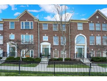 Charming brick townhomes featuring manicured landscaping and a classic, welcoming exterior at 8613 N Meridian St, Indianapolis, IN 46260