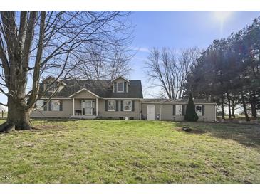 Charming two-story home featuring green shutters and a spacious front yard on a sunny day at 11686 S 825 W, Edinburgh, IN 46124