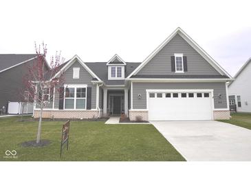 Charming, gray, two-story home with a well-manicured lawn and attached two-car garage at 1274 Clairet, Westfield, IN 46074