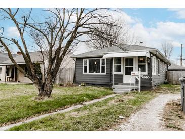 Charming single-story home with a well-manicured lawn and inviting front porch at 4910 East 21St St, Indianapolis, IN 46218