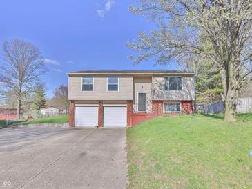 Two-story home with two-car garage, brick accents, and a well-maintained front yard at 7733 Opelika Ct, Indianapolis, IN 46217