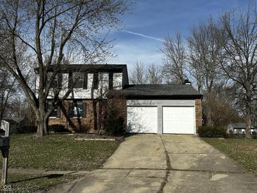 Charming two-story home with a two-car garage and a well-maintained front yard, perfect for Gathering living at 8054 Harvest Ln, Indianapolis, IN 46256