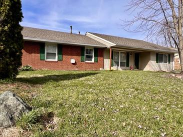 Charming single story house with brick and vinyl siding and well maintained front yard at 810 Fabyan Rd, Indianapolis, IN 46217