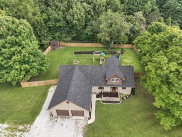 A beautiful aerial view of this home features a well-maintained lawn and a fenced backyard for outdoor enjoyment at 859 E Bunkerhill Rd, Mooresville, IN 46158