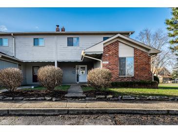 Charming two-story townhouse with brick accents and manicured landscaping at 11931 E Welland St, Indianapolis, IN 46229