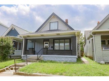 Charming home featuring a covered front porch and classic architectural details at 1715 Fletcher Ave, Indianapolis, IN 46203