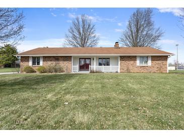 Charming single-story brick home with a well-manicured lawn, front porch and classic architectural details at 298 Northridge Dr, Mooresville, IN 46158