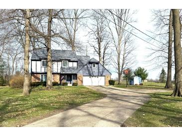 Charming two-story home with well-maintained lawn and two-car garage at 5967 Oak Hill East Dr, Plainfield, IN 46168