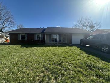 Charming single-story home boasts a well-maintained lawn and a classic brick facade at 731 W Stop 11 Rd, Indianapolis, IN 46217
