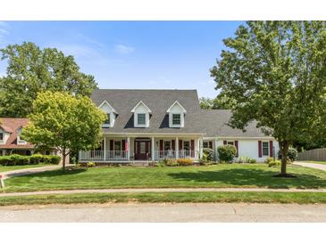 Charming single Gathering home with a well-manicured lawn and inviting front porch at 7341 Campfire Run, Indianapolis, IN 46236