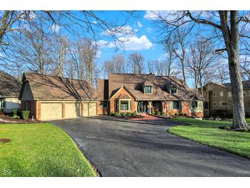 Charming brick home featuring a two-car garage, brick walkway, and beautifully landscaped front yard at 9334 Seascape Dr, Indianapolis, IN 46256