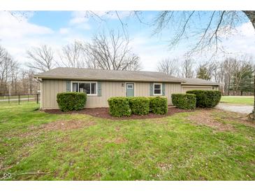 Charming one-story home featuring lush landscaping and a well-maintained front yard at 2072 S Rembrandt Cv, Martinsville, IN 46151